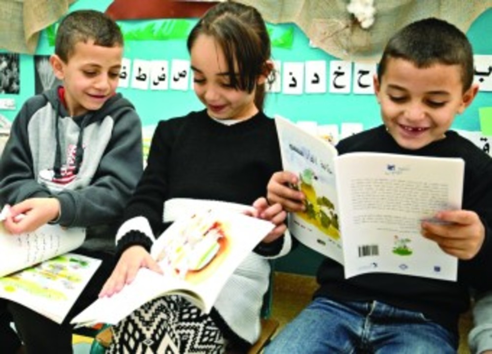 Israeli Arab children at a school in Baqa al-Gharbiyye  reading books from the Lantern Library, a spinoff of the  Harold Grinspoon Foundation’s PJ Library. /Harold Grinspoon Foundation